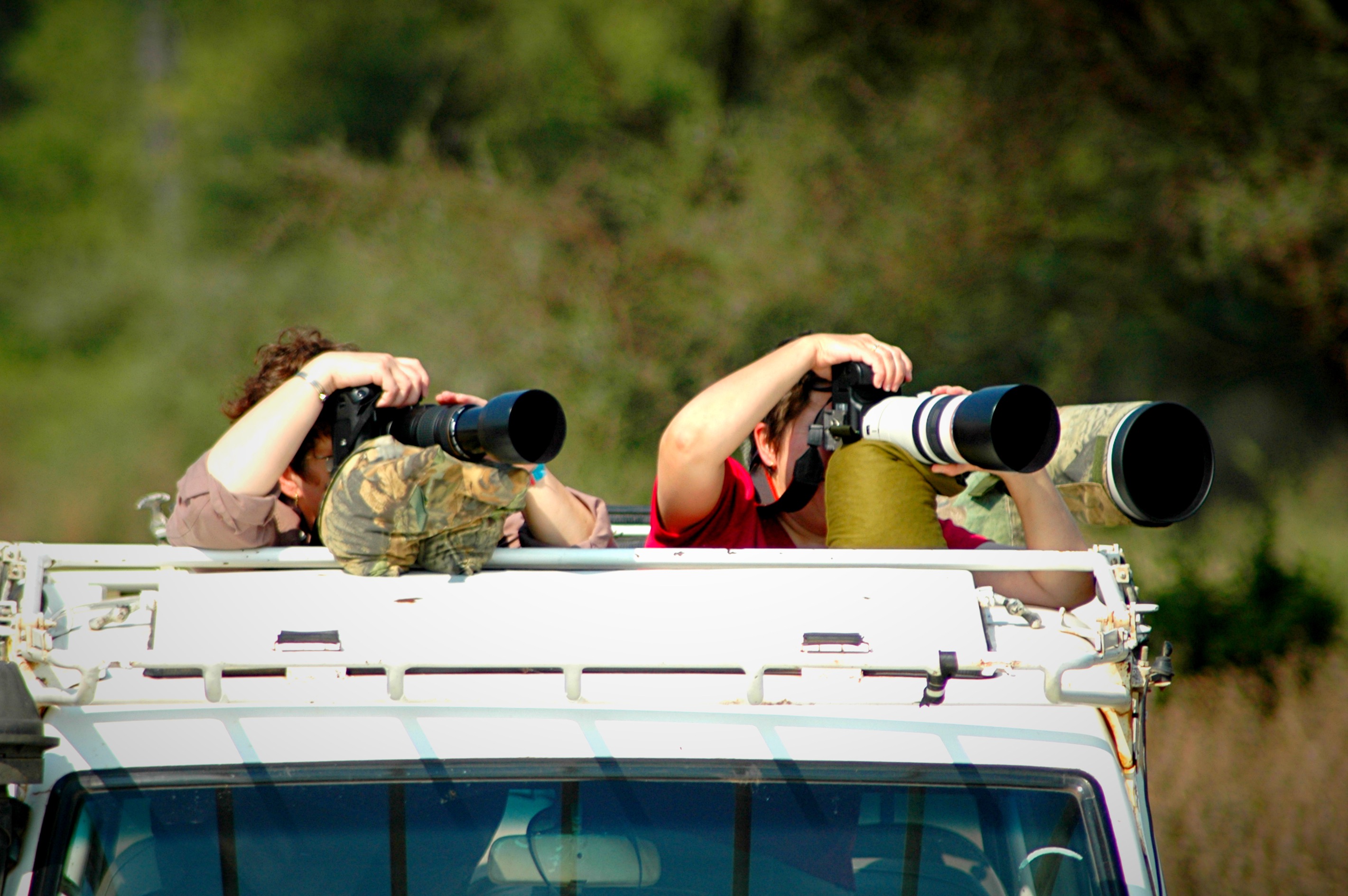 Camera with telephoto lens on a bean bag mount in a luxury safari vehicle in Tanzania ready for wildlife photography