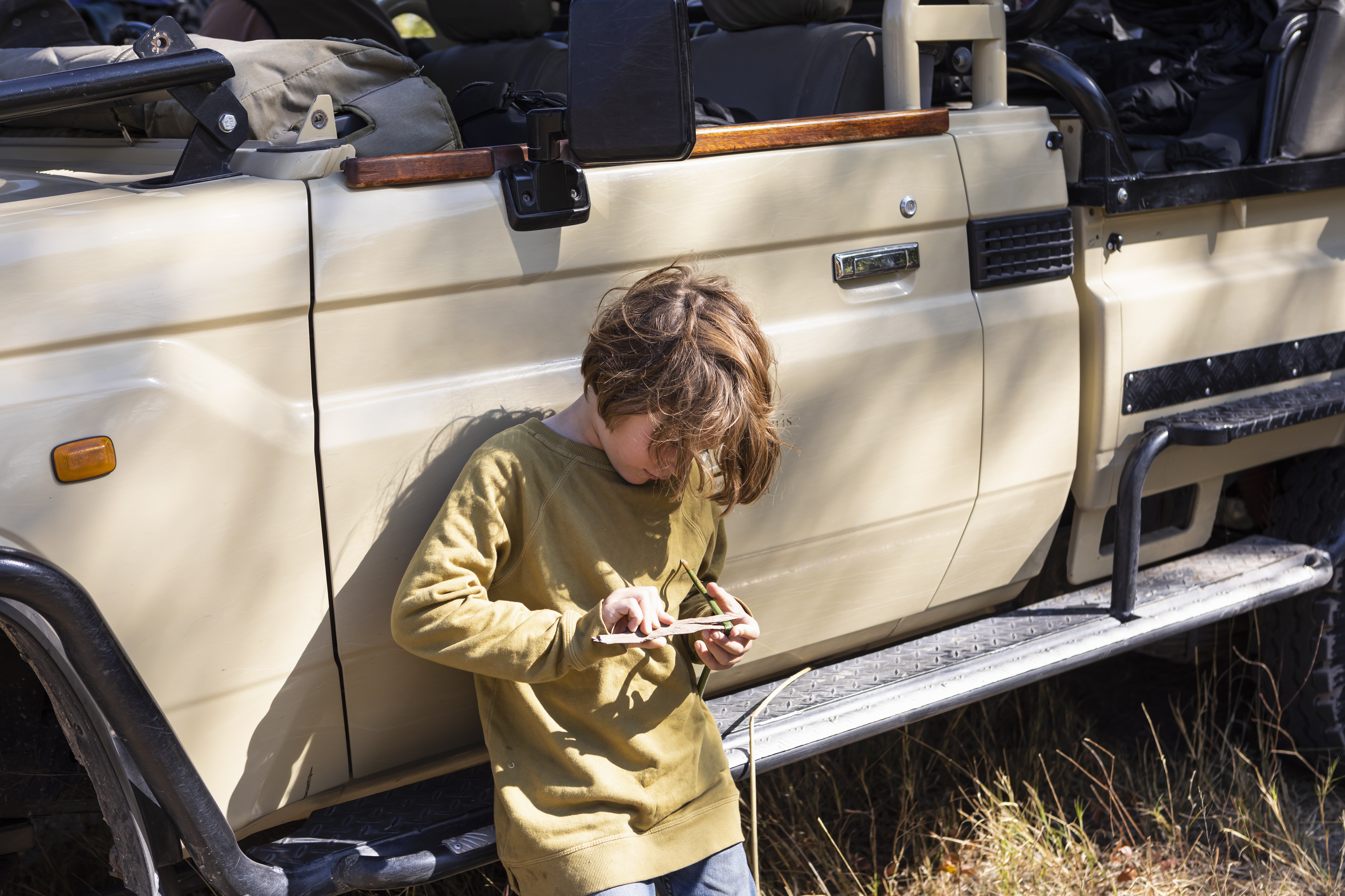 Off-road private safari vehicle tracking lions in a Tanzania private concession at dawn — an experience only available outside national park boundaries