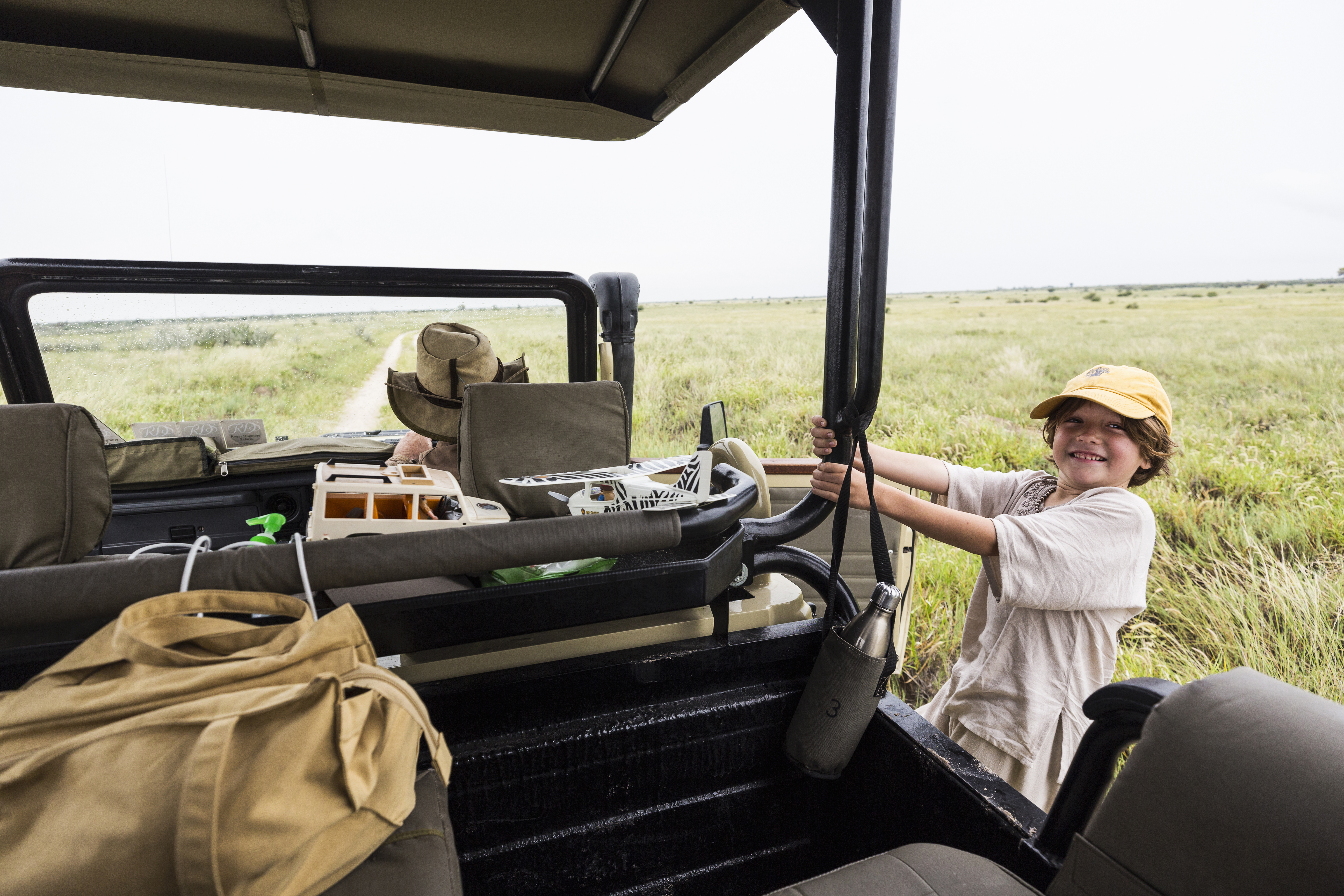 Safari specialist and clients reviewing a bespoke Tanzania private safari itinerary map with camp brochures and route options