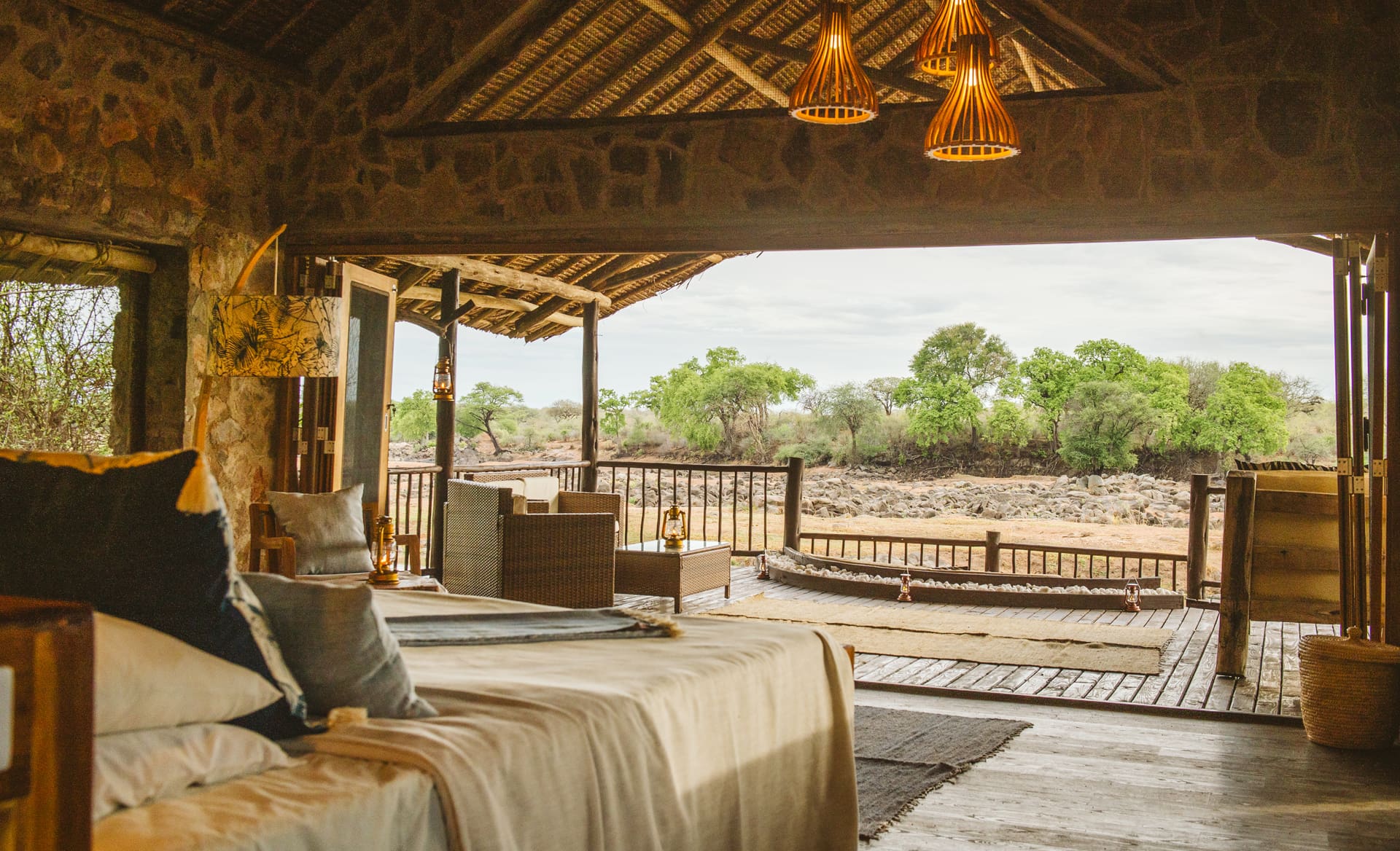 Luxury safari lodge overlooking the Great Ruaha River in Tanzania's Ruaha National Park with elephants at the water